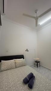 a bed with a pillow on it in a bedroom at Homestay Rumi in Macang +6 photos