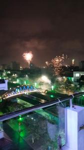 Blick auf eine Stadt in der Nacht mit Feuerwerk in der Unterkunft HOA MAI Plus Hostel in Dong Hoi