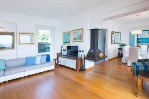 a living room with a couch and a fireplace at Villa Arona in Arona