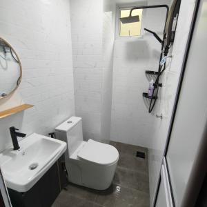 a bathroom with a white toilet and a sink at Fayyadh Homestay Selayang - 3 Bilik 2 Bilik Air -malay only in Batu Caves