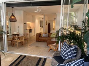 a living room with a couch and a table at Carramah Noosa Heads apartment in Noosa Heads
