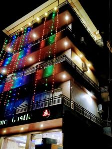 a building with christmas lights on the side of it at Hotel King Castle Central Heated & Air cooled in Dharamshala