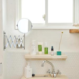 a bathroom with a sink and a mirror and a sink at SMALL TOWN HOTEL Hakodate in Hakodate