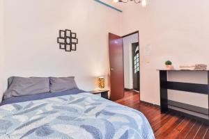 a bedroom with a bed and a table in it at HOSTAL ROMA in Mexico City
