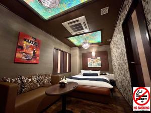 A bed or beds in a room at Hotel Asian Color (Adult Only)