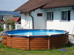 a large pool in the yard of a house at Penzion u Vichu in Červená Voda
