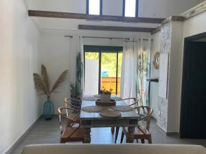 a dining room with a table and chairs in a room at Villa MYA Location in Saint-Pierre