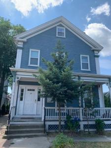 a blue house with a tree in front of it at Beautiful Townhouse, 2 bedrooms, 2 bath in Boston