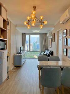 a living room with a dining table and a living room with a view at SWSB Home — 3BR Apartment in Jakarta City Centre in Jakarta