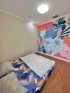 a bedroom with a bed and a floral wall at SWSB Home — 3BR Apartment in Jakarta City Centre in Jakarta