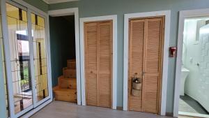 two wooden doors in a room with stairs at Haumok52 Udo in Jeju +88 photos