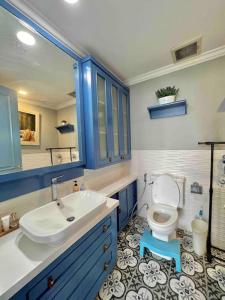 a bathroom with a white toilet and a sink at SWSB Home — 3BR Apartment in Jakarta City Centre in Jakarta