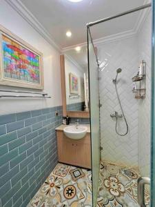 a bathroom with a shower with a sink and a sink at SWSB Home — 3BR Apartment in Jakarta City Centre in Jakarta