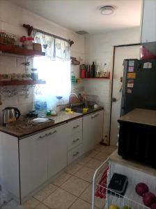 uma cozinha com um lavatório e um frigorífico em Habitación en casa Familiar em Viña del Mar
