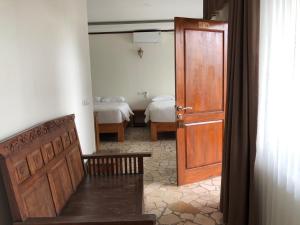 a room with a door and a bedroom with two beds at Edge Resort, Yogyakarta in Parangtritis