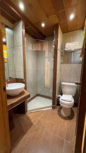 a bathroom with a toilet and a sink and a shower at CITI HOTEL in Hilongos