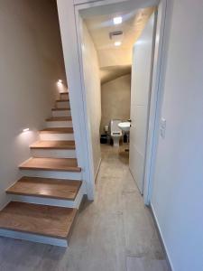 a hallway with stairs and a bathroom with a toilet at Areti 1 & Areti 2 in Kilada