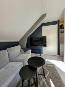 een woonkamer met een bank en een tafel bij Cozy 2bdr apt. 3 min walk to Solsiden in Trondheim