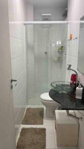 a bathroom with a toilet and a glass sink at Apto 3 dorm, aconchegante , próximo a beira mar . in Florianópolis +33 photos