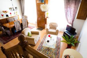 a living room with a couch and a table at La Petite Maison près de l'Eglise in Meillac