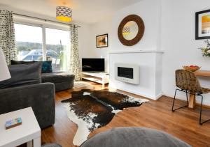 a living room with a couch and a tv at Hillview in Llanbedrog