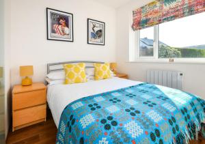 a bedroom with a large bed and a window at Hillview in Llanbedrog