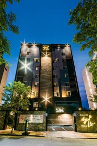 a tall building with lights on top of it at Hotel Ssome Jeongkwan in Busan