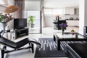 uma sala de estar com um sofá e uma mesa em BYD Lofts - Boutique Hotel & Serviced Apartments - Patong Beach, Phuket em Patong Beach
