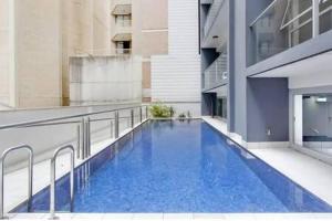a large blue swimming pool on the side of a building at A Comfy Studio for 5 Next to Darling Harbour in Sydney