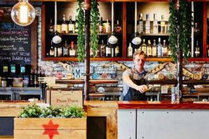 a man behind the counter of a bar at A Comfy Studio for 5 Next to Darling Harbour in Sydney