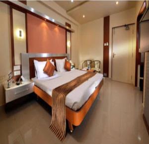 a bedroom with a large bed in a room at NavaRATNA Delight in Coimbatore