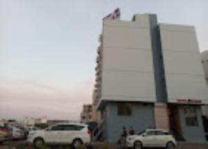 a group of cars parked in front of a building at Hotel Krish , Somnath in Somnath