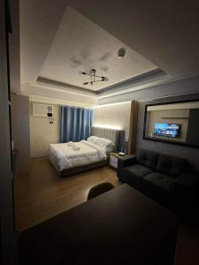 a hotel room with a bed and a couch at Abreeza Place T2 - 720 in Davao City