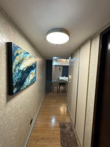 a hallway with a painting hanging on a wall at Abreeza Place T2 - 720 in Davao City