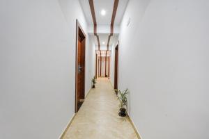 a corridor of a house with white walls and ceilings at FabHotel Tree Suites in Bangalore