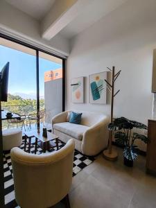 a living room with a couch and a table at Urban Gem: Comfort, Style, Views. Apartment close to the AIRPORT in Guatemala