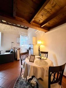 a dining room with a table and a kitchen at Renaissance Suite in Ferrara