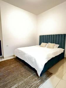 um quarto com uma cama grande e uma cabeceira verde em 1BR Luxury Apartment close to JBR Beach Marina em Dubai