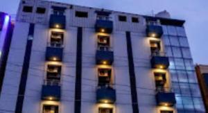 a building with lights on the side of it at Hotel Riverfront , Prabhas Patan in Somnath