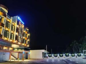 a hotel at night with a parking lot at Hotel Riverfront , Prabhas Patan in Somnath