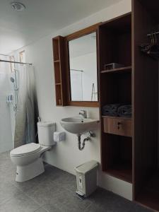 a bathroom with a toilet and a sink at Uma Pantai Seseh in Canggu