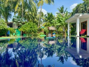 a swimming pool in front of a villa at Bella Nilaveli Beach in Nilaveli