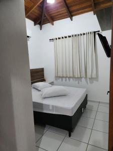 a bedroom with a bed and a window at Sobrado bem localizado em Praia de Boiçucanga in São Sebastião