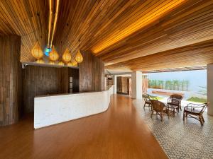 a living room with a table and chairs at Plernpetch Hotel in Surat Thani