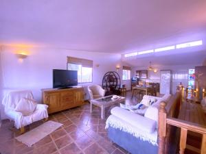 a living room with white furniture and a flat screen tv at Tropicalidays Oceanview Chayofa in Chayofa