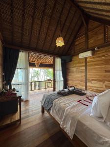 a bedroom with a bed in a wooden room at Uma Pantai Seseh in Canggu