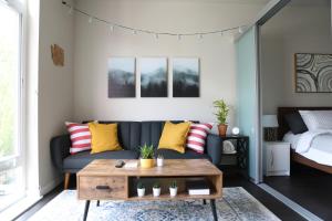 a living room with a couch and a coffee table at Queen Anne Abode - 1 Block from CPA! - Free Parking! in Seattle