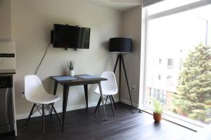 a dining room with a table and chairs and a tv at Queen Anne Abode - 1 Block from CPA! - Free Parking! in Seattle