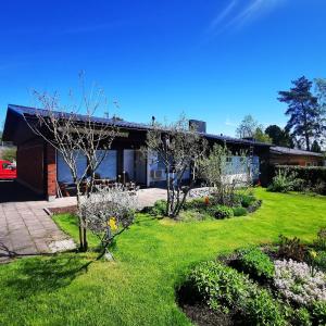 a house with a green yard with trees and flowers at Anttoninvahe 7 130m2 with garden and sauna etc in Rauma