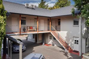 a house with a staircase on the side of it at Elphin Serviced Apartments in Launceston